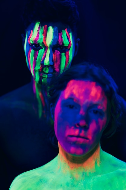 Free photo fluorescent make-up on woman and man face