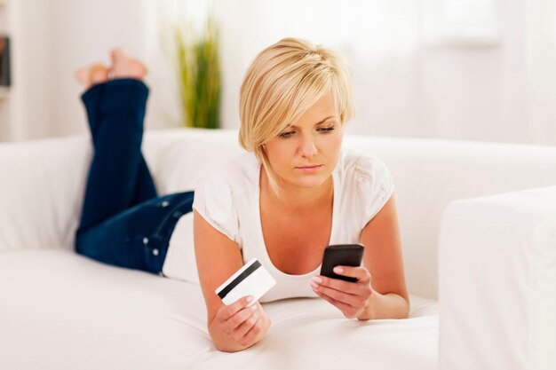 Focus woman holding mobile phone and credit card