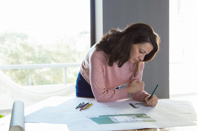 Focused architect working on building plan