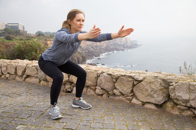 Focused athlete girl working on physical endurance