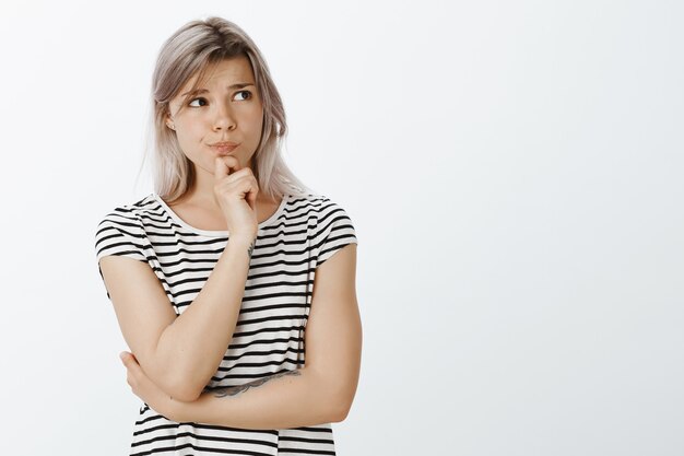 Focused blonde girl posing in the studio