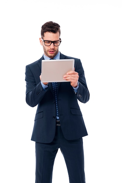 Focused businessman using a digital tablet
