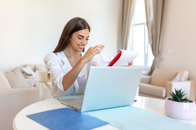 Focused businesswoman presenting charts and graphs on video call online Young business woman having conference call with client on laptop Closeup business woman working laptop computer indoor