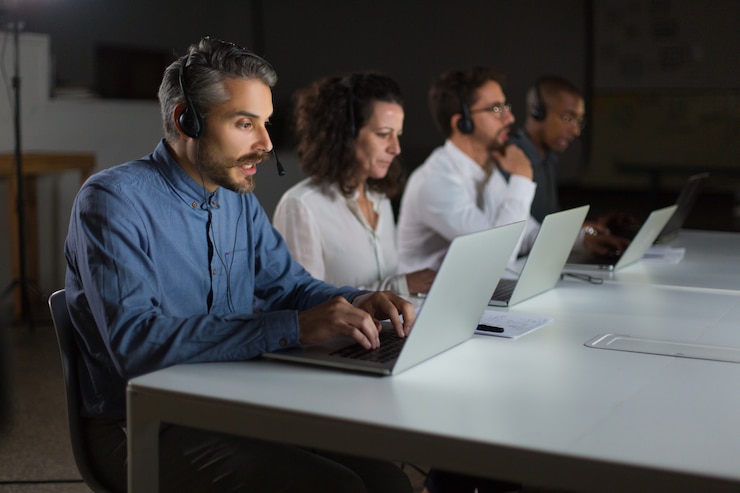 Free Photo focused call center operators during working process