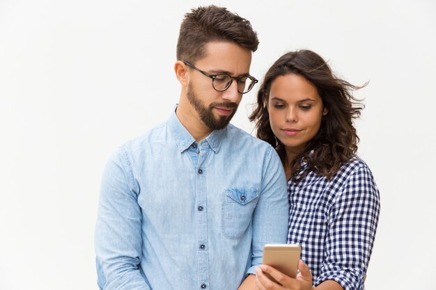 Focused couple reading message