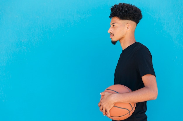 Focused ethnic player with basketball