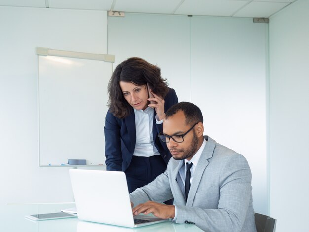 Focused female manager talking to client