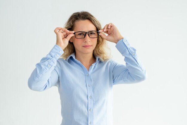 Focused frowning office girl staring at camera