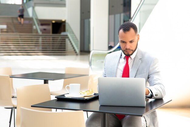 Focused hardworking businessman working on project