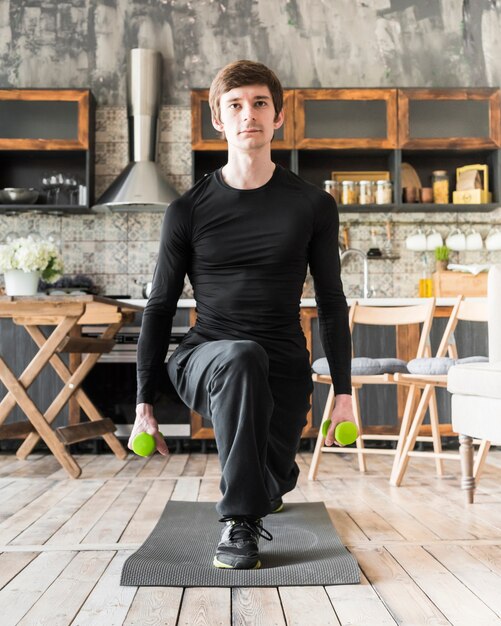 Focused man exercising with dumbbells