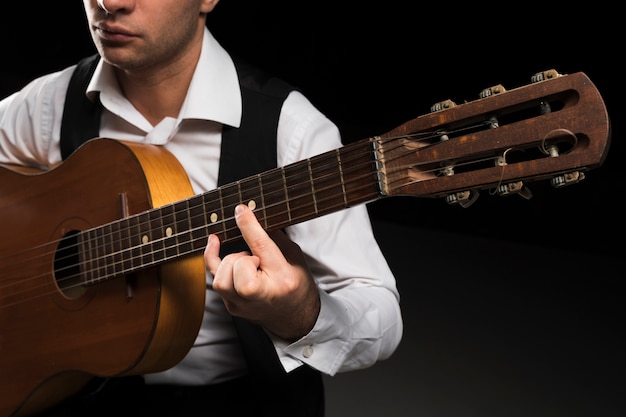 Focused man playing notes on guitar