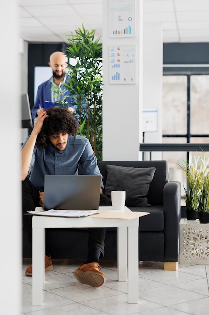 Free photo focused manager thinking about solving financial ptoblem on laptop