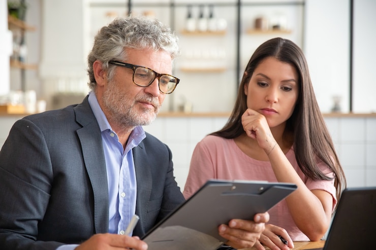 Free Photo focused mature legal advisor reading and analyzing customer document
