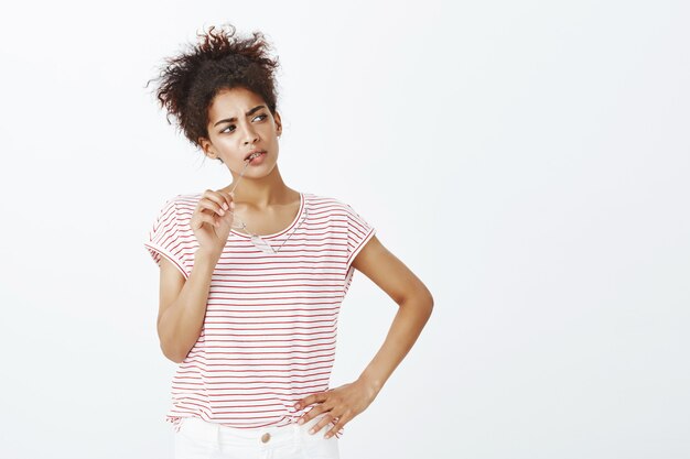 focused woman with afro hairstyle posing in the studio