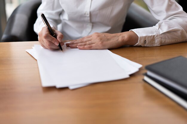 Focused woman writing on blank paper