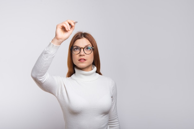 Free photo focused woman writing something in air