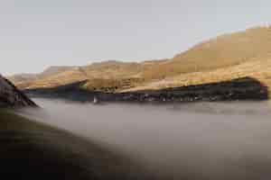 Free photo fog covering rimetea village in romania; scenic hills in the background