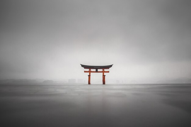 Foggy shot of the floating torii of Miyajima, Japan during rain