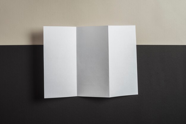 Folded blank paper on backdrop