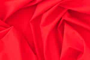 Free photo folded red textile fabric texture background