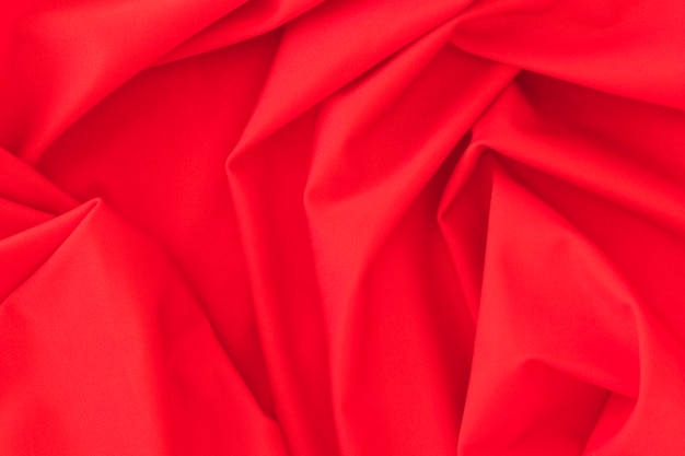 Folded red textile fabric texture background