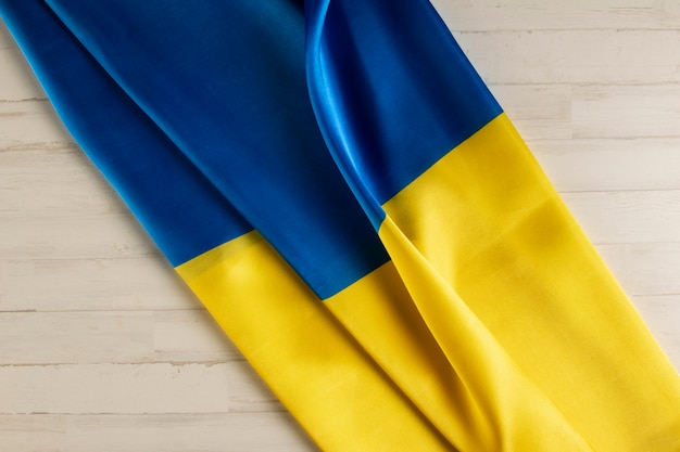 Free photo folded ukranian flag still life above view