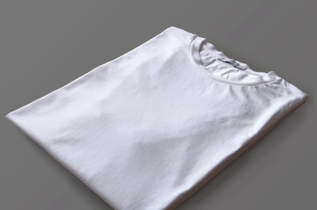 Folded white tshirt over wood surface