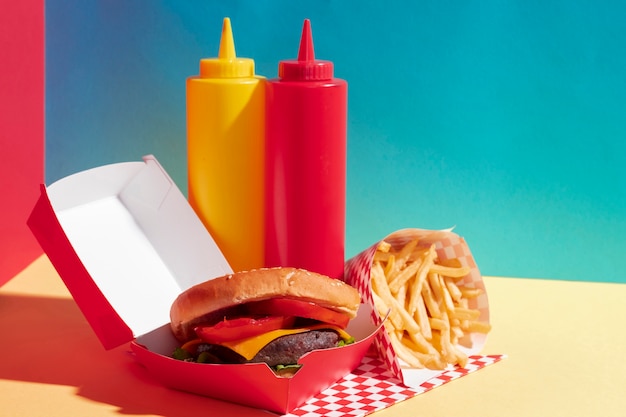 Food assortment with burger and sauce bottles