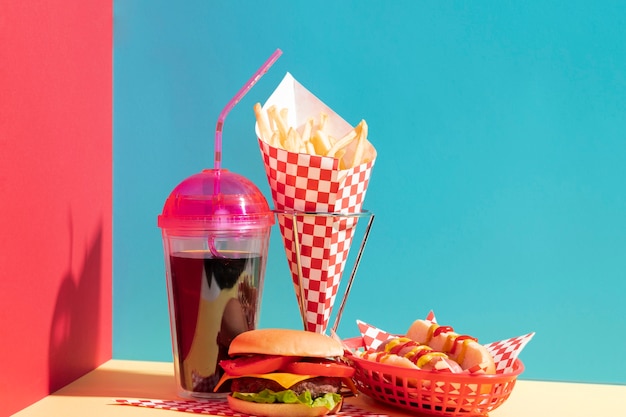 Food assortment with juice cup and cheeseburger