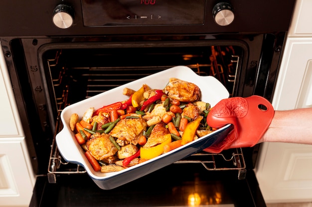 Free photo food being put into oven to cook