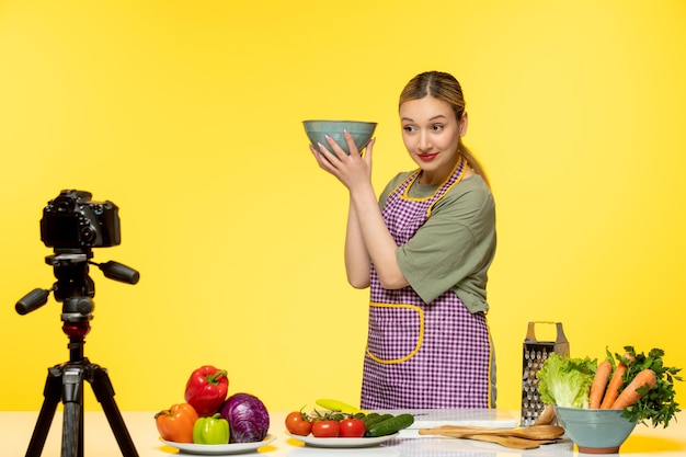 Free photo food blogger adorable healthy chef recording video for social media holding bowl