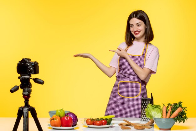 Food blogger cute fitness cook recording video for social media pointing to left