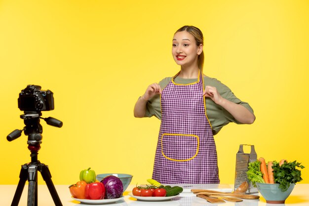 Food blogger cute healthy chef recording video for social media taking apron off