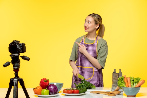 Food blogger pretty cute healthy chef recording video for social media pointing up