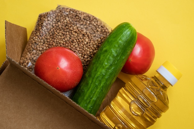 Еда в картонной коробке на желтом фоне