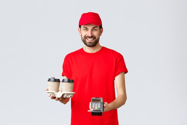 Food delivery quarantine stay home and order online concept friendly bearded courier in red uniform ...