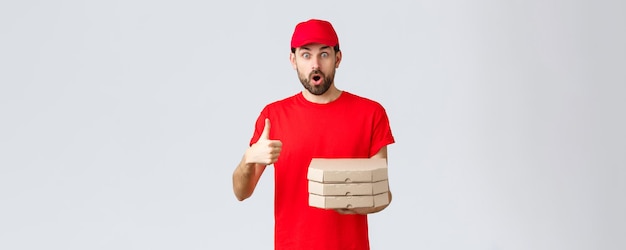 Food delivery quarantine stay home and order online concept surprised and amazed bearded courier in ...