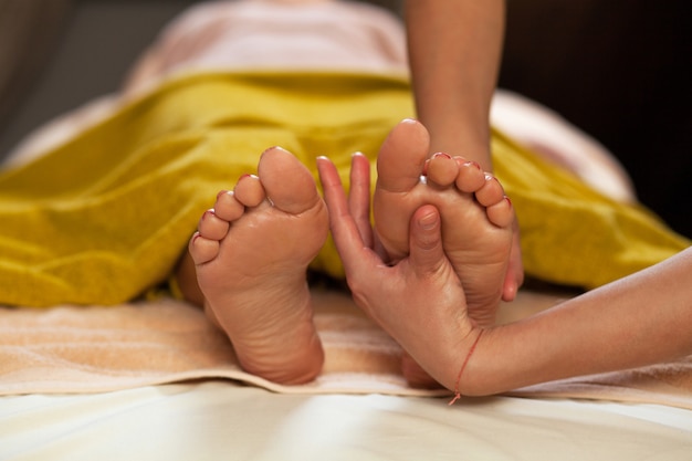 Foot massage for a woman in a spa 