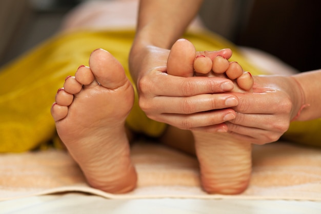 Foot massage for a woman in a spa 