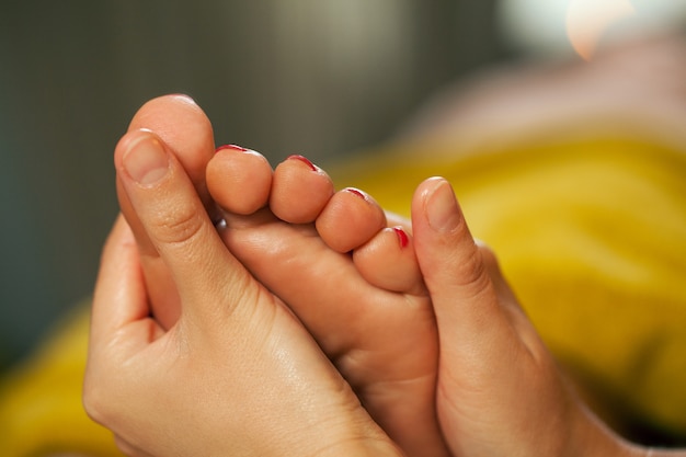 Foot massage for a woman in a spa 