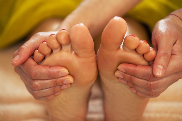 Foot massage for a woman in a spa 