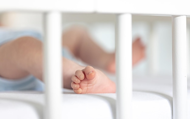 Foot of a newborn baby in bed macro shot