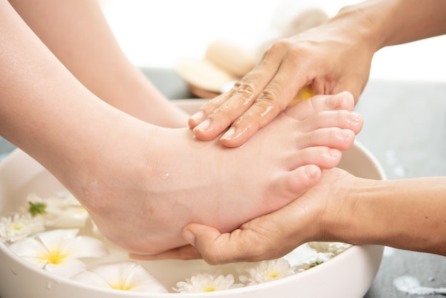 foot washing in spa before treatment. spa treatment and product for female feet and hand spa.