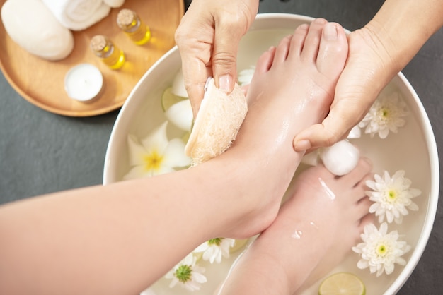 Free Photo foot washing in spa before treatment. spa treatment and product for female feet and hand spa.