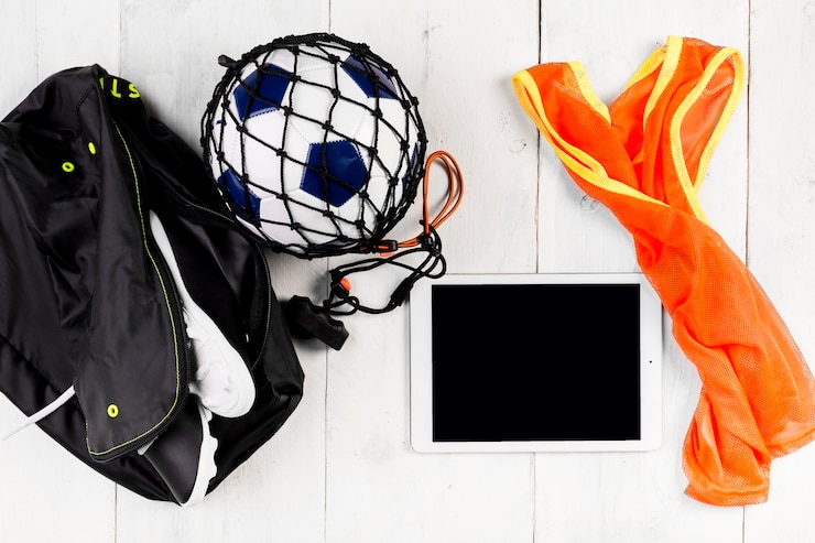 Free Photo football composition with ball in net and bag