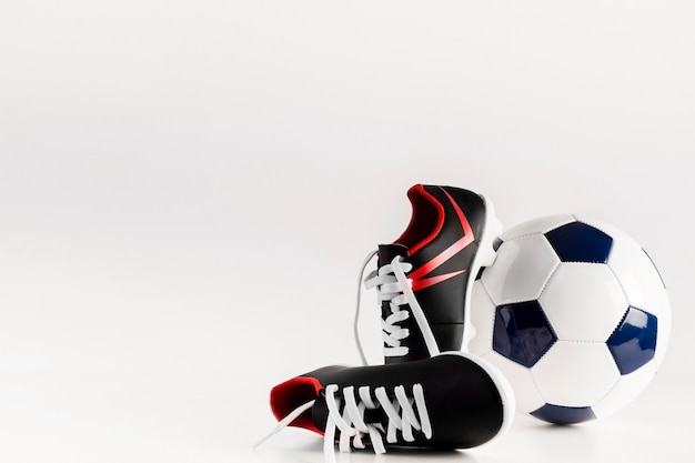 Free photo football composition with shoes and ball