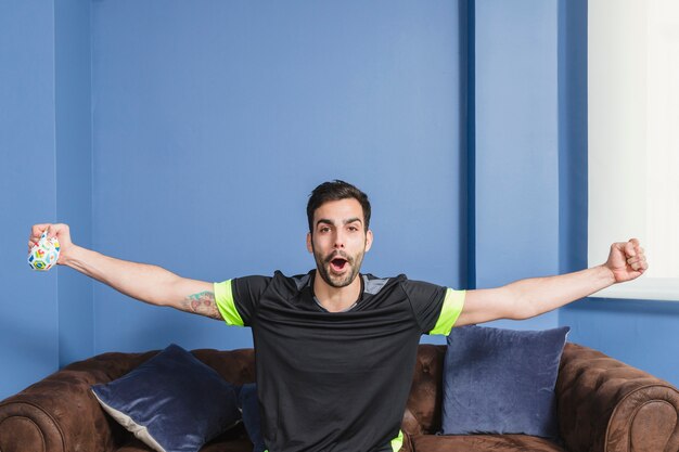 Football fan celebrating on couch