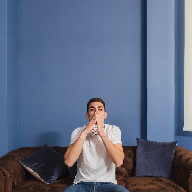 Free photo football fan on couch