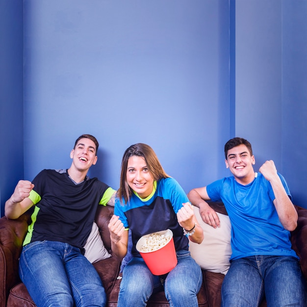 Football fans celebrating at home