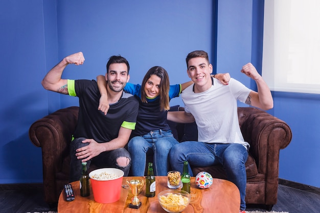 Football fans celebrating in living room